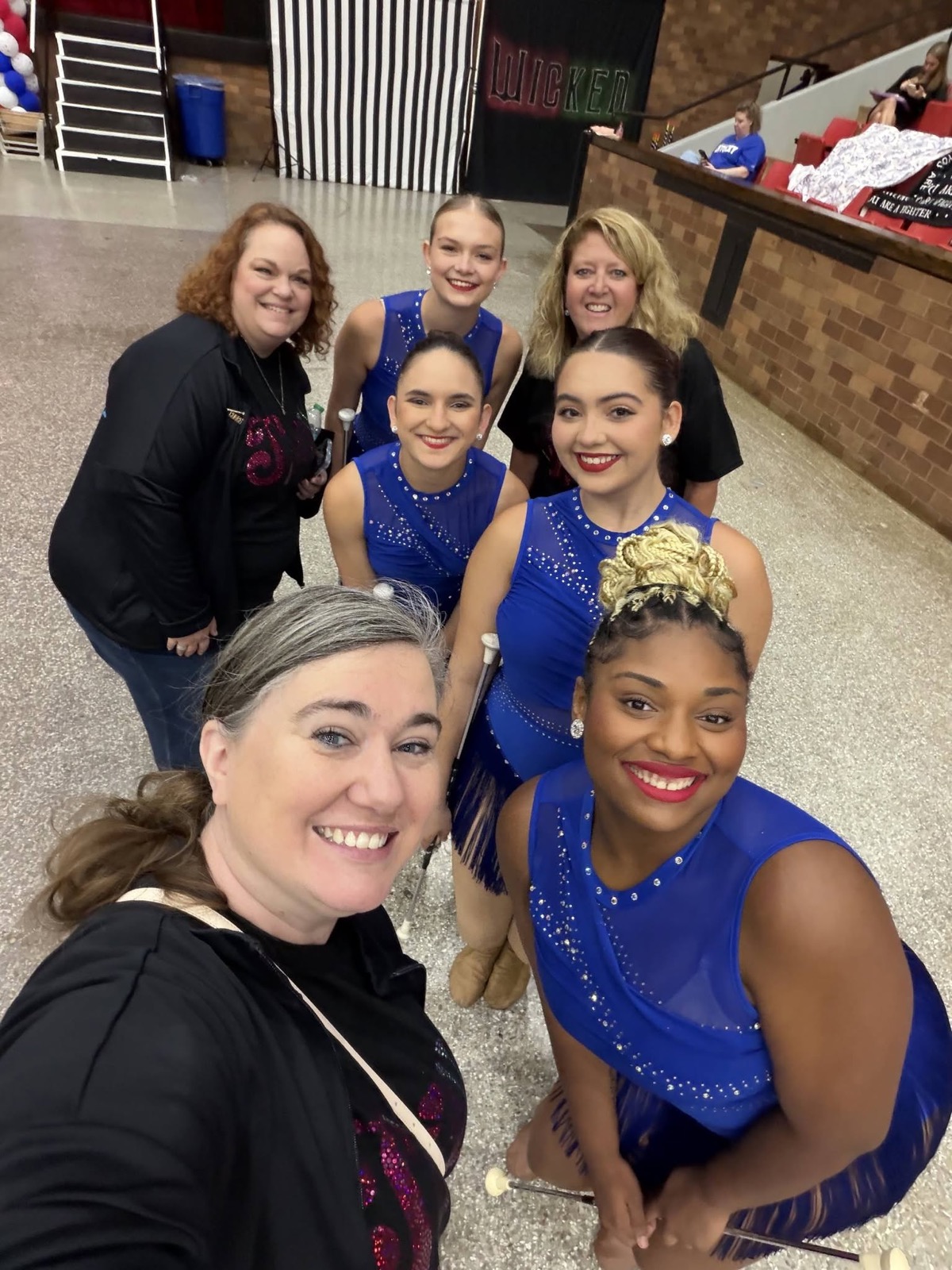 Spirit Baton coaches with the team at a competition