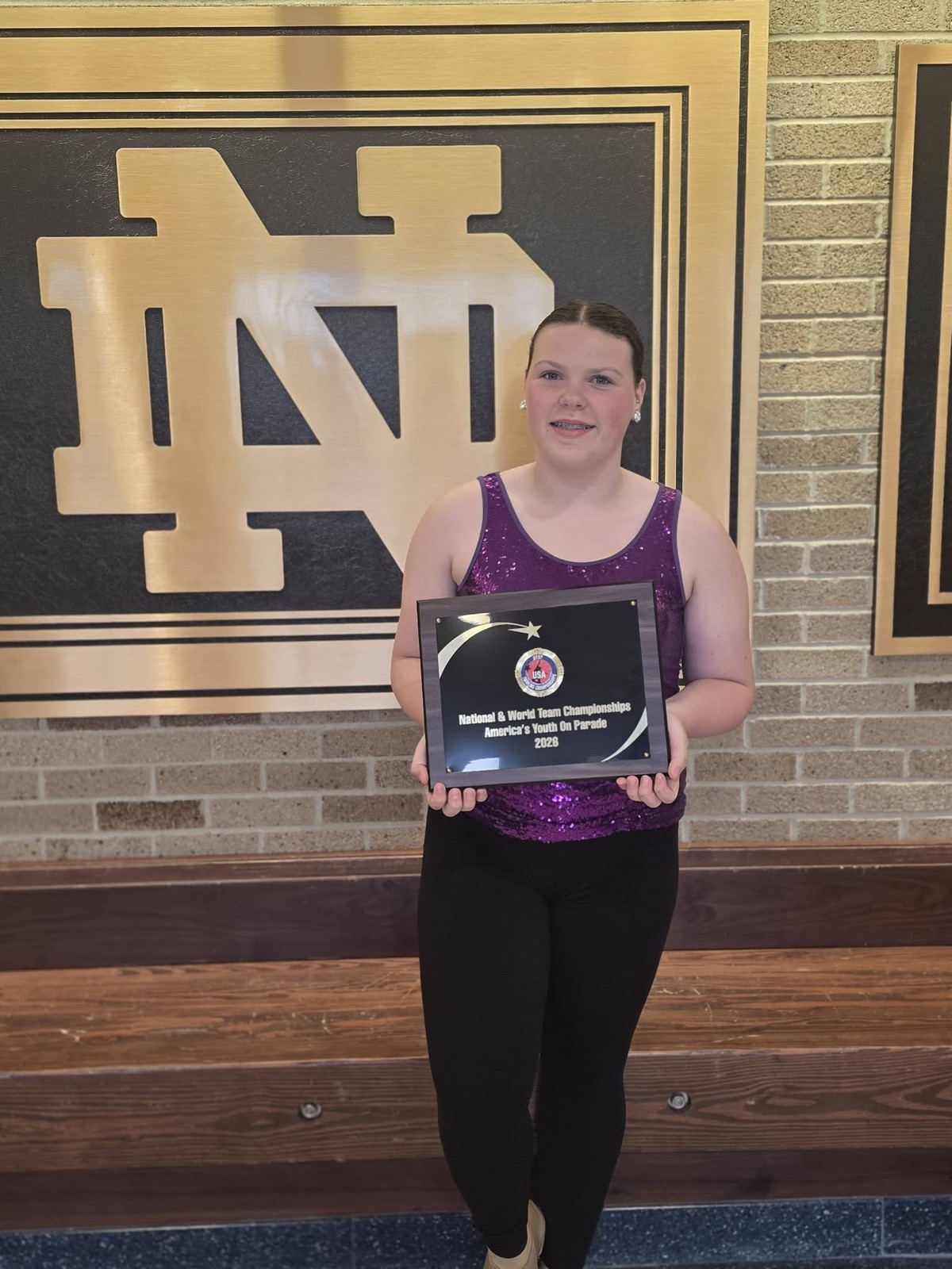 Spirit Baton twirler with her championship plaque