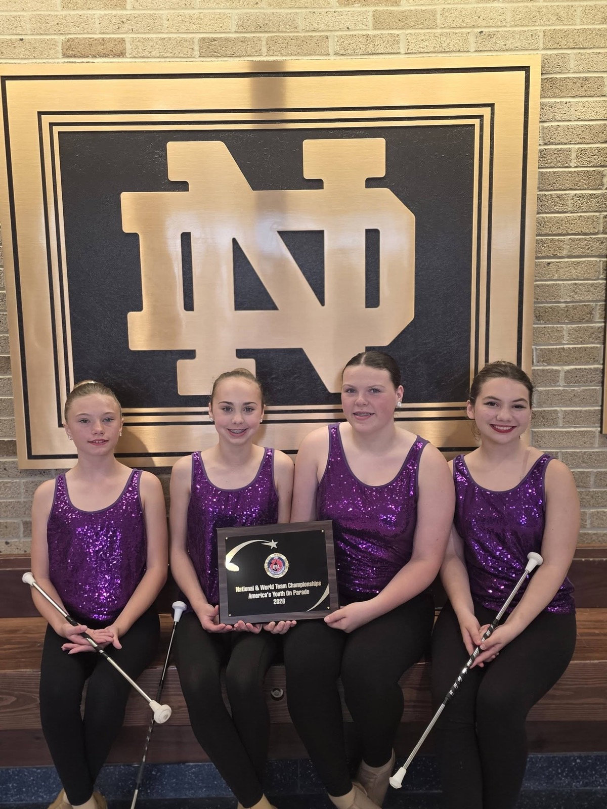 Spirit Baton twirlers with their championship plaque